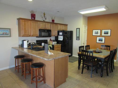 a kitchen and dining room with a counter and chairs at Walk-in Condo A-4 in Hollister