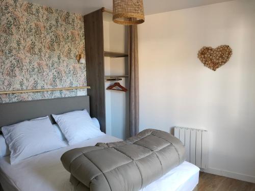a bedroom with a bed and a heart wall at L'intemporelle in Le Crotoy