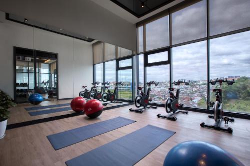 a gym with a bunch of exercise bikes in a room with windows at INNSiDE by Meliá Kuala Lumpur in Kuala Lumpur