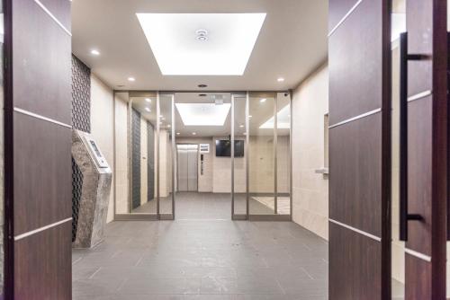a corridor of a hospital hallway with wooden doors at Apartment Hotel 11 Kuromon in Osaka
