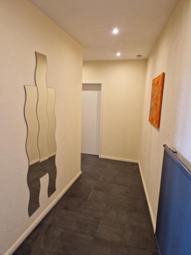 a hallway with black and white paintings on the wall at Wohnen auf Zeit City Speyer in Speyer
