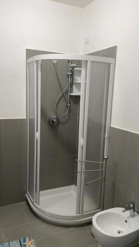 a shower in a bathroom with a toilet and a sink at Appartamento monolocale vista mare FT6 in Cascabraga