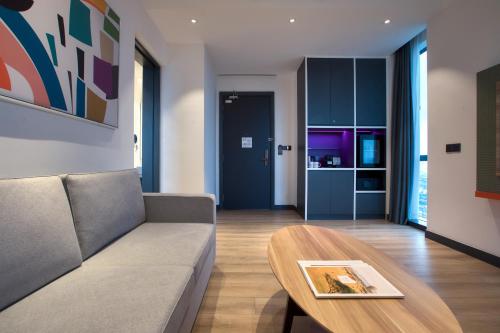 a living room with a couch and a table at INNSiDE by Meliá Kuala Lumpur in Kuala Lumpur