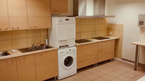 a kitchen with a washing machine and a sink at AKADUS Noclegi in Łomża