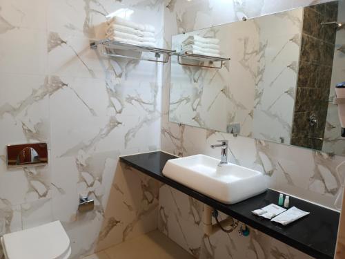 a bathroom with a sink and a mirror at CLIFFVIEW RESORT in Yercaud