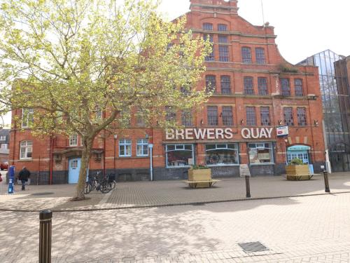 a large brick building with a brewers only sign on it at Monarch in Weymouth