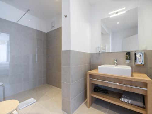 a bathroom with a sink and a mirror at MyFavorit Apartments - Spacious Apartments next to Puplic Transport U1 direct connection to Citycenter in Vienna