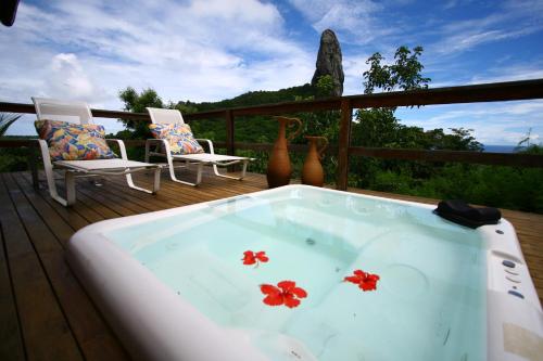 a bath tub with flowers in it on a deck at Pousada Zé Maria in Fernando de Noronha