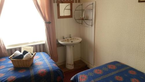 a small bathroom with a sink and a sink at The Derby Hotel in Blackpool