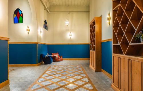 a room with blue walls and a stained glass window at Kubler's House - By Beach Apartments TLV in Tel Aviv