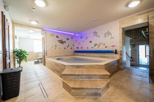 a large bathroom with a tub in a room at Penzión Pltník in Červený Kláštor