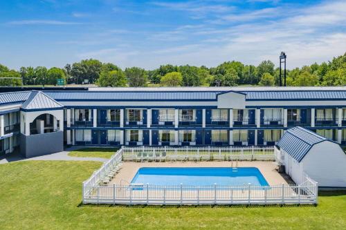 a large building with a swimming pool in front of it at Days Inn by Wyndham Owensboro in Owensboro