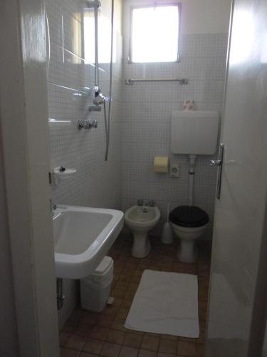 a bathroom with a sink and a toilet at Hotel Busignani in Rimini