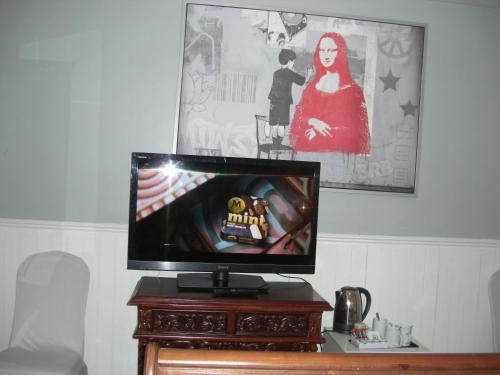 a flat screen tv sitting on top of a wooden table at Lynebank House Hotel, Bed & Breakfast in Carlisle