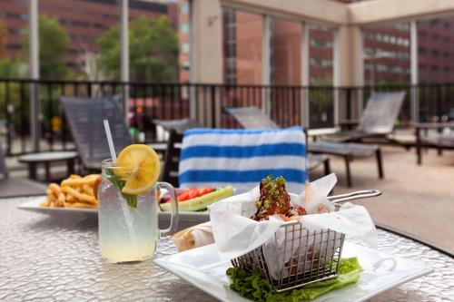 a table with two plates of food and a drink at Wyndham Boston Beacon Hill in Boston