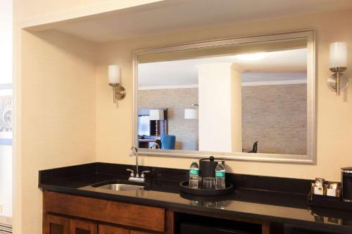 a bathroom with a sink and a large mirror at Wyndham Boston Beacon Hill in Boston