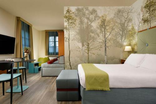 a hotel room with a bed and a desk at Villa Appiani Hotel in Trezzo sullʼAdda