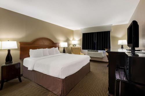 a hotel room with a bed and a television at Revel Hotel Minot - SureStay Collection by Best Western in Minot