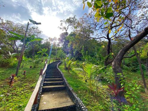a set of stairs in a park with trees at CED Garden in El Nido