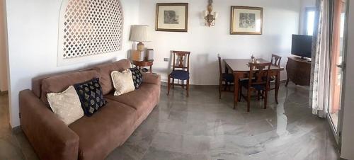 a living room with a couch and a table at Acquamarina - vue mer in Nice