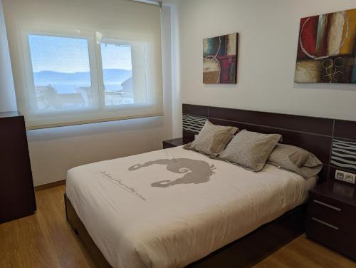 A bed or beds in a room at Apartamento 2 habitaciones con vistas en la playa