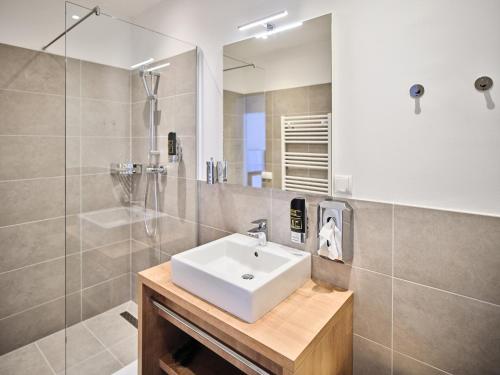 a bathroom with a sink and a shower at MyFavorit Apartments - Spacious Apartments next to Puplic Transport U1 direct connection to Citycenter in Vienna