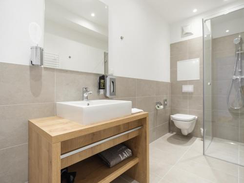 a bathroom with a sink and a toilet at MyFavorit Apartments - Spacious Apartments next to Puplic Transport U1 direct connection to Citycenter in Vienna