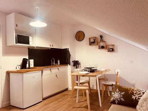 a kitchen with a table and a small kitchen with a dining room at Le pti ‘ P2000 in Bolquere Pyrenees 2000