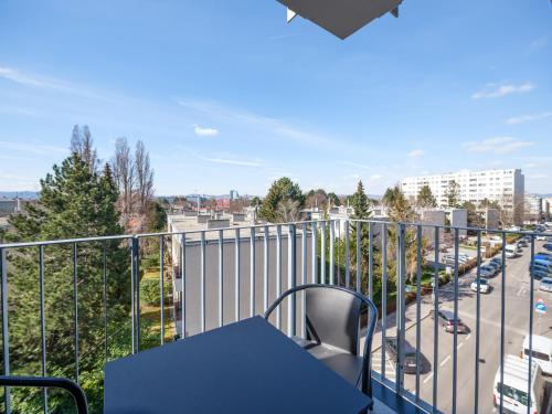 a balcony with a table and a view of a street at MyFavorit Apartments - Spacious Apartments next to Puplic Transport U1 direct connection to Citycenter in Vienna