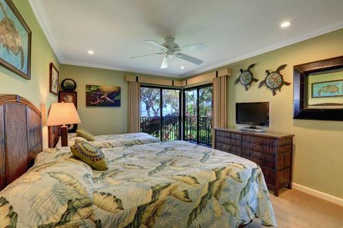 a bedroom with a large bed and a television at WAILEA ELUA, #1204 condo in Wailea