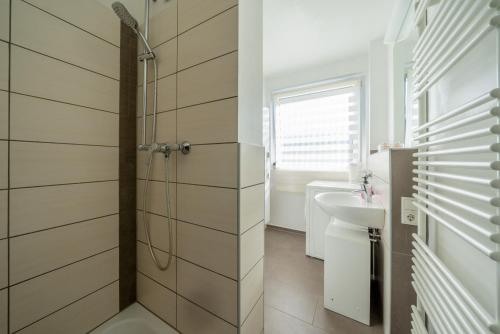 a bathroom with a shower and a sink at Private Apartment in Lehrte