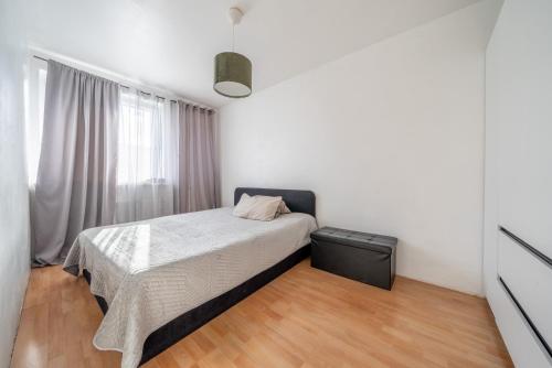 a small bedroom with a bed and a window at Private Apartment in Lehrte