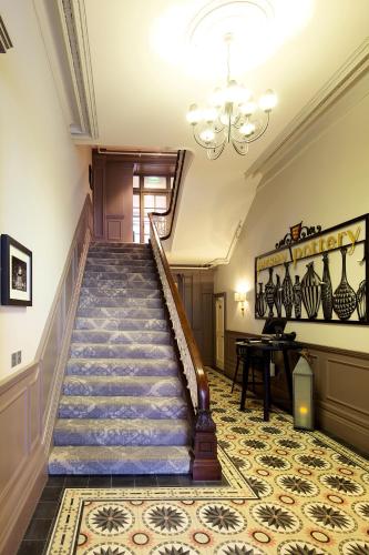 a spiral staircase in a building with a chandelier at 8 Beresford Street in Saint Helier Jersey