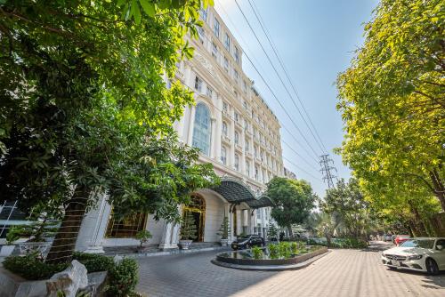 a building on a street with cars parked in front of it at Cozrum Homes - Sonata Residence in Ho Chi Minh City