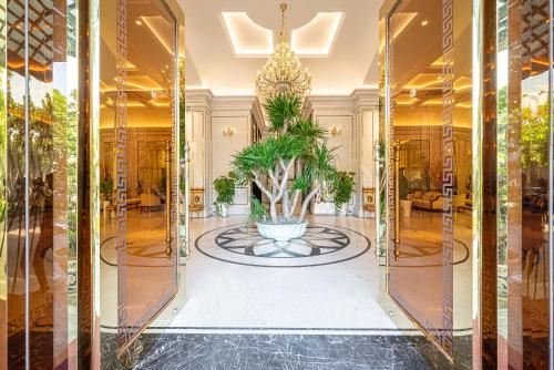 a lobby with a potted plant in a fountain at Cozrum Homes - Sonata Residence in Ho Chi Minh City