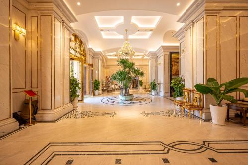 a large hallway with a lobby with plants in it at Cozrum Homes - Sonata Residence in Ho Chi Minh City