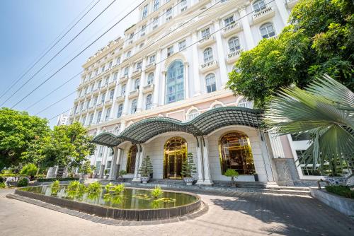 a building with a fountain in front of it at Cozrum Homes - Sonata Residence in Ho Chi Minh City