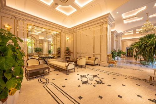 a large room with a lobby with couches and tables at Cozrum Homes - Sonata Residence in Ho Chi Minh City