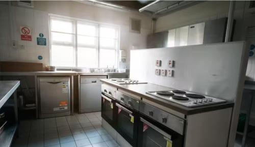 a kitchen with a stove top oven in a kitchen at Cunninghame 2 in Beith