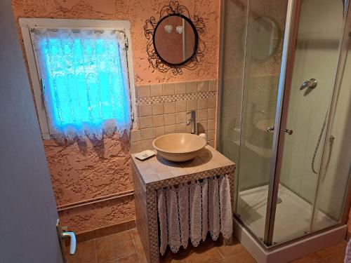 a bathroom with a sink and a shower at Lou Pin dou Papet in Roquevaire