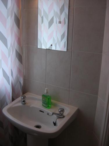a bathroom with a sink and a mirror at Lynebank House Hotel, Bed & Breakfast in Carlisle