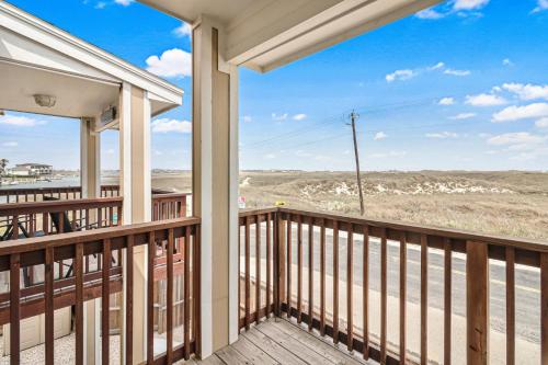 a balcony of a house with a view of the desert at Chillin' Channelside in Padre Island