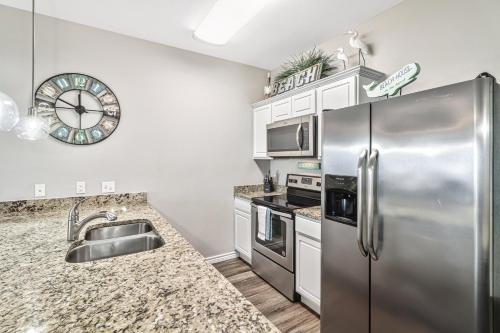 a kitchen with stainless steel appliances and granite counter tops at Chillin' Channelside in Padre Island