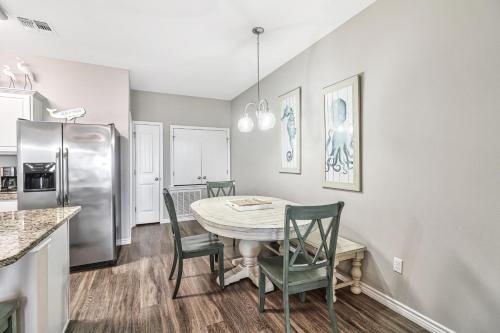 a kitchen with a table and chairs and a refrigerator at Chillin' Channelside in Padre Island