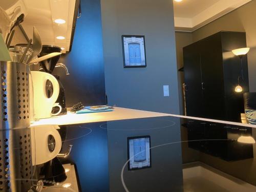 a kitchen with blue walls and a counter top at Magnolia House Norrviken in Sollentuna