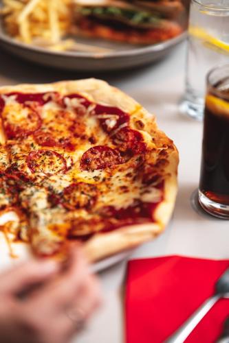 a slice of pizza sitting on top of a table at Novotel Southampton in Southampton