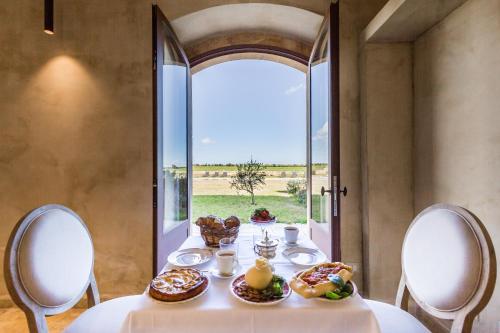 stół z jedzeniem w pokoju z oknem w obiekcie Casa Vendicari Boutique Hotel w mieście Noto