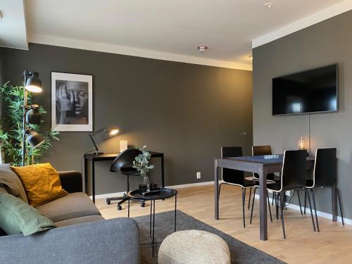 a living room with a couch and a table at Magnolia House Norrviken in Sollentuna