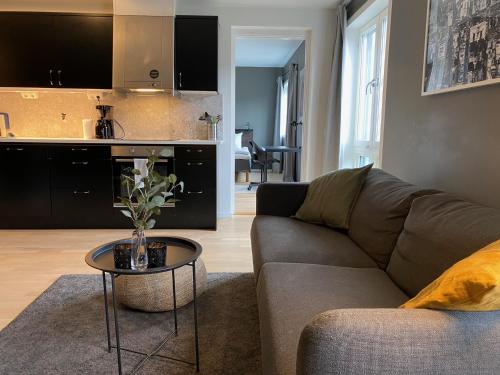 a living room with a couch and a table at Magnolia House Norrviken in Sollentuna