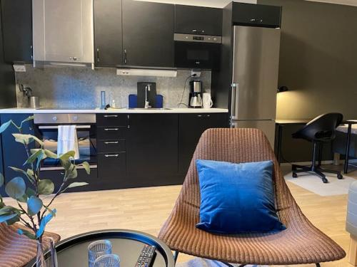 a kitchen with a blue pillow on a chair at Magnolia House Norrviken in Sollentuna